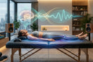 A woman resting deeply on a vibroacoustic therapy bed in a calming, dimly lit room, with visual graphics illustrating therapeutic sound waves soothing her musculoskeletal system and promoting sleep-inducing brainwave entrainment.