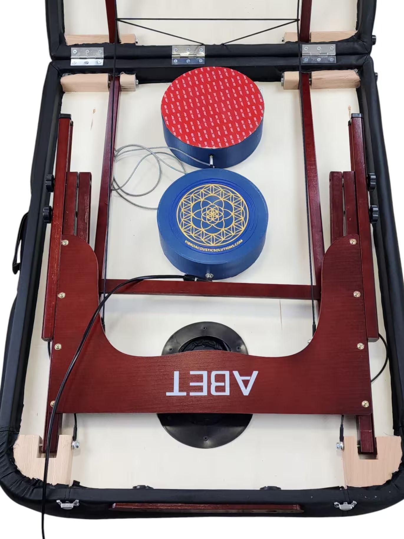 Vibroacoustic therapy massage table attachments showcasing a wooden frame and placement of attachments on the table, designed to enhance massage practices.